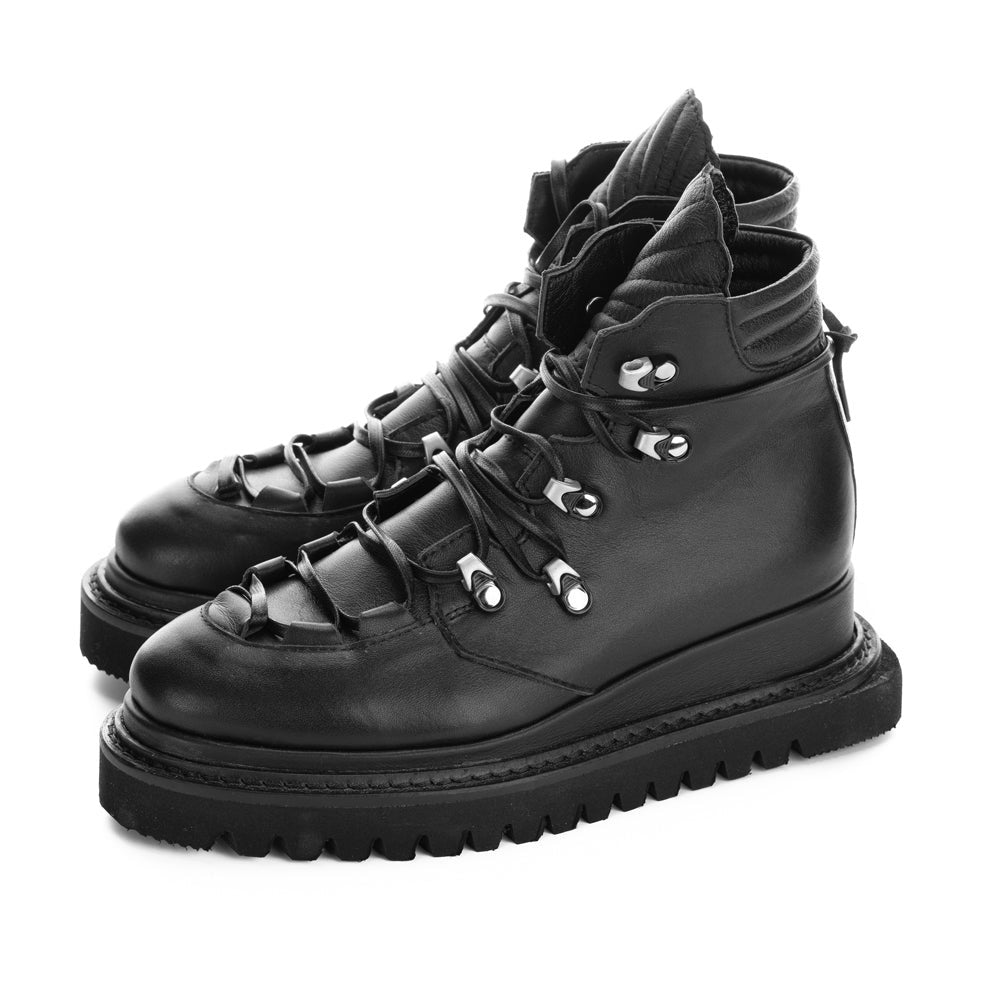 Black leather lace-up booties with shell-quilted leather details and metallic accessories