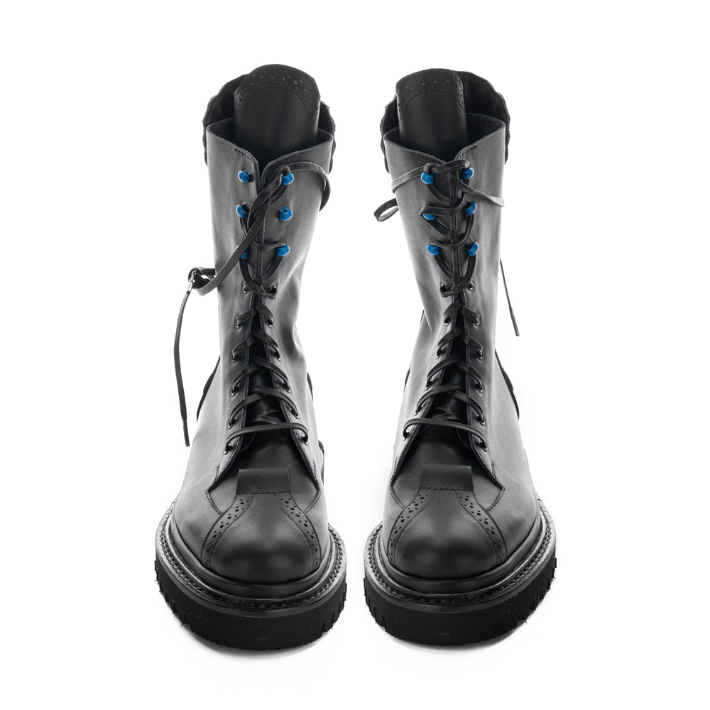 Handcrafted leather boots with black geometric sole