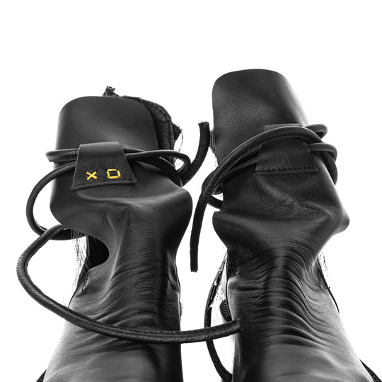 XOXO Paper Game black leather cut-out booties