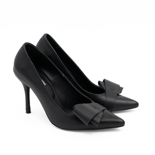 After Party black leather pumps with bow details and slender stiletto heels, side-angle view.