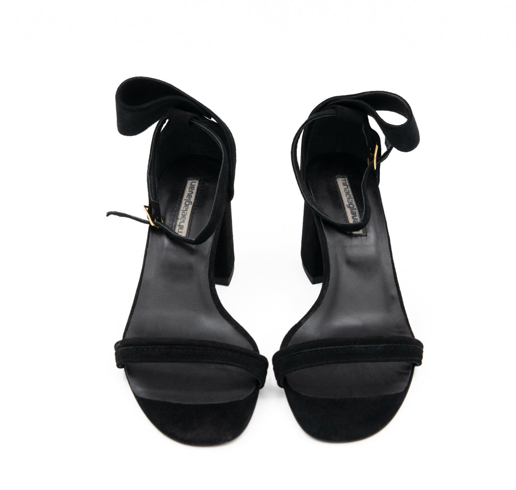 Front view of Back to Bow black suede sandals, with slim toe straps and natural leather lining.