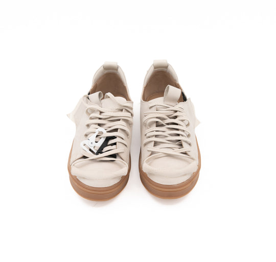 Front view of Crossroads light beige nubuck sneakers, showing the matching laces and metallic accessories.