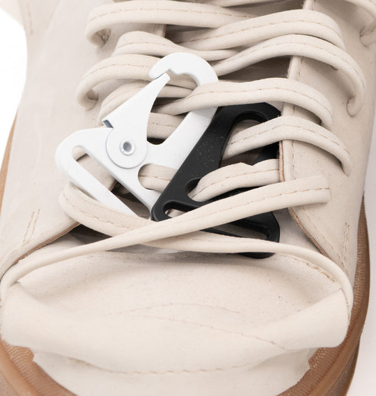 Close-up of the laces and metallic accessories on Crossroads light beige nubuck sneakers.
