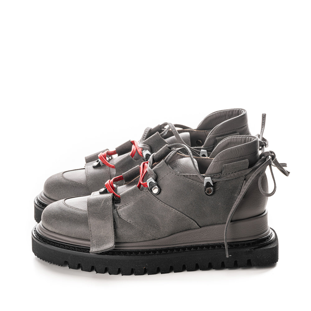 Unique shoes with red/grey leather laces and metallic accessories