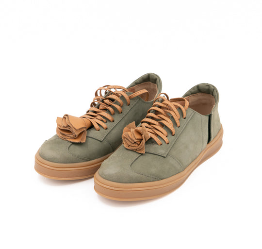 Make This Flower Great Again light khaki nubuck sneakers with tan laces and sculptural flowers, three-quarter view.