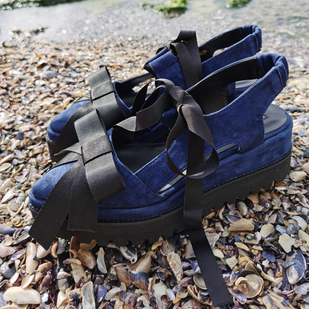 Navy suede shoes with black ribbed textile bow details