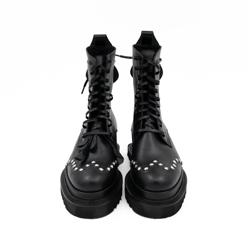 Punk Dreamer black leather lace-up booties by Mihaela Glavan, front view showing the waxed cotton laces and studded floral details.