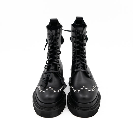 Punk Dreamer black leather lace-up booties by Mihaela Glavan, front view showing the waxed cotton laces and studded floral details.