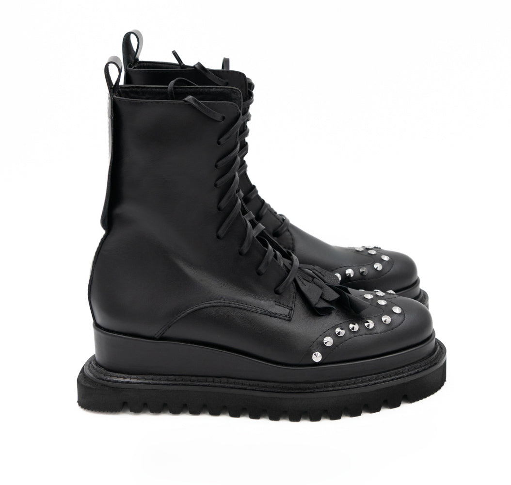 Punk Dreamer black leather lace-up booties by Mihaela Glavan, side view showing the leather upper and geometric sole.