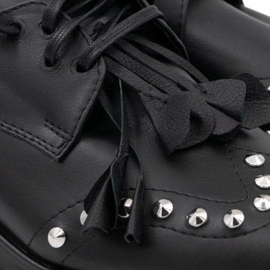 Punk Dreamer black leather lace-up shoes by Mihaela Glavan, close-up of the raised leather flower, waxed laces and metal studs.