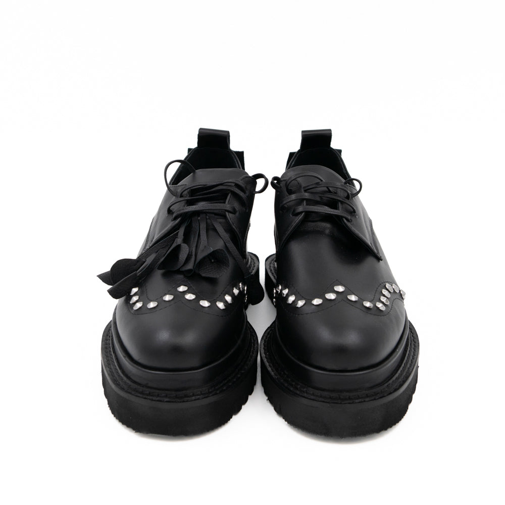 Punk Dreamer black leather lace-up shoes by Mihaela Glavan, front view showing the laces and studded toe details.