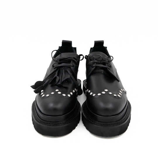 Punk Dreamer black leather lace-up shoes by Mihaela Glavan, front view showing the laces and studded toe details.