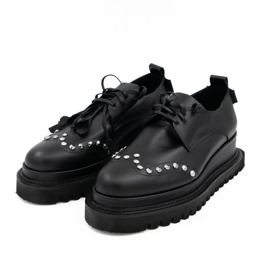 Punk Dreamer black leather lace-up shoes by Mihaela Glavan, opposite three-quarter view showing the textured leather flowers and studs.