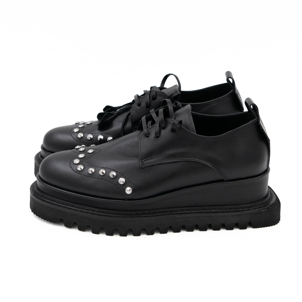 Punk Dreamer black leather lace-up shoes by Mihaela Glavan, side view of the black leather upper and geometric sole.