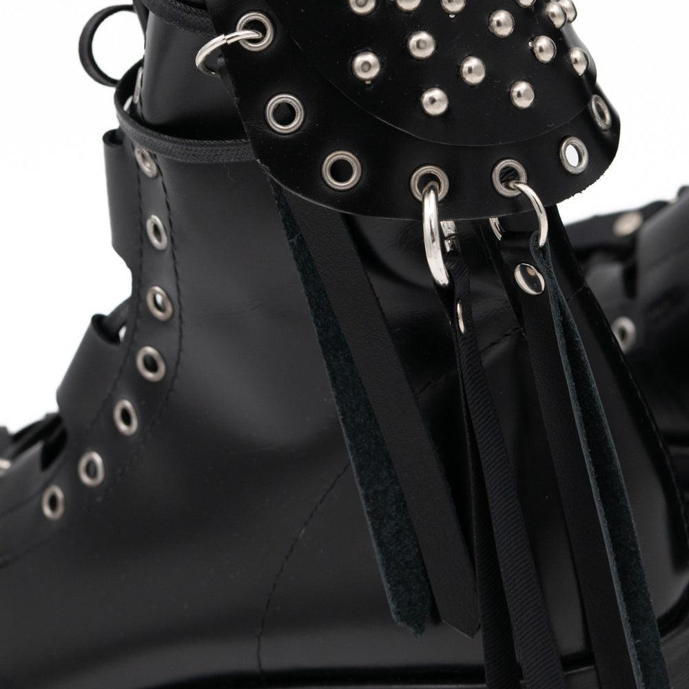 Punk Lover black leather lace-up booties by Mihaela Glavan, close-up of the metal studs, rings and hanging leather strips.