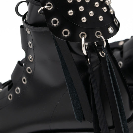 Punk Lover black leather lace-up booties by Mihaela Glavan, close-up of the metal studs, rings and hanging leather strips.