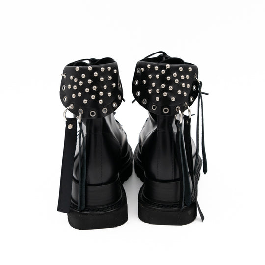Punk Lover black leather lace-up booties by Mihaela Glavan, back view showing the studded panels and long leather strips.