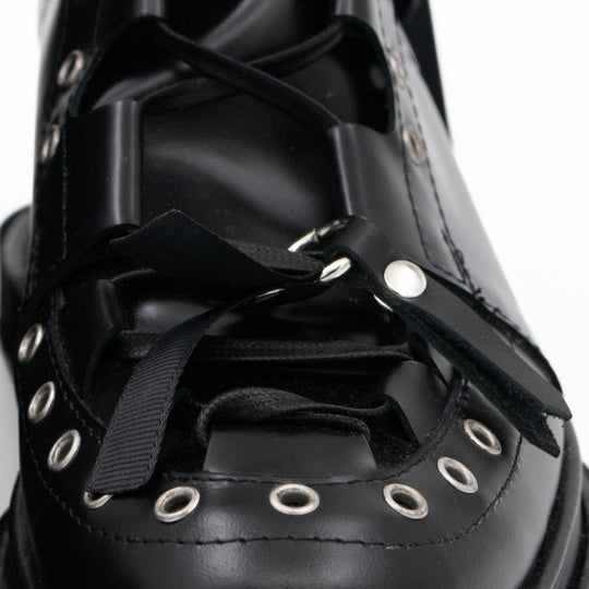 Punk Lover black leather lace-up booties by Mihaela Glavan, close-up of the eyelet details and black laces.