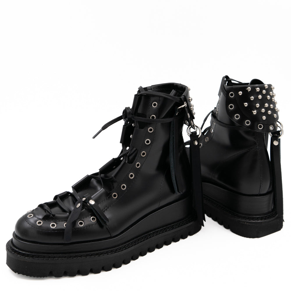 Punk Lover black leather lace-up booties by Mihaela Glavan, paired view showing the front of one boot and the back of the other.