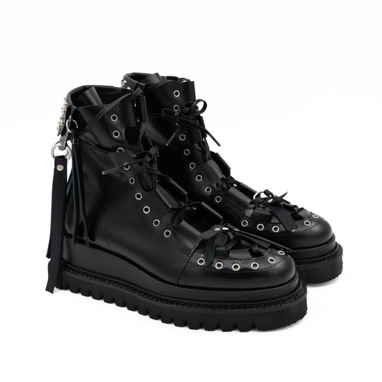Punk Lover black leather lace-up booties by Mihaela Glavan, three-quarter view showing the eyelets, studs and hanging back details.