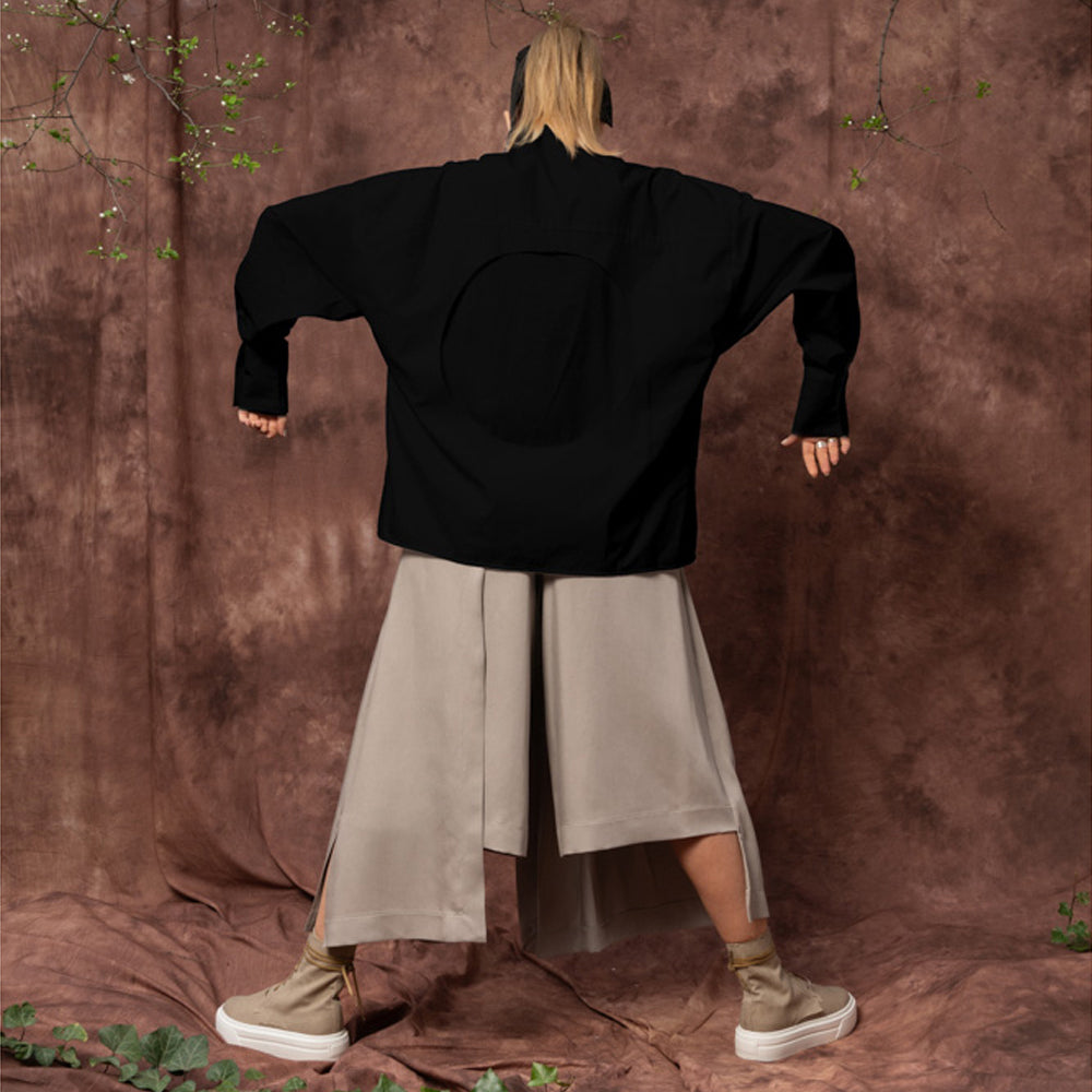 Back view of the Solar Disk black oversized shirt by Mihaela Glavan, showing the circular cut-out and relaxed silhouette.