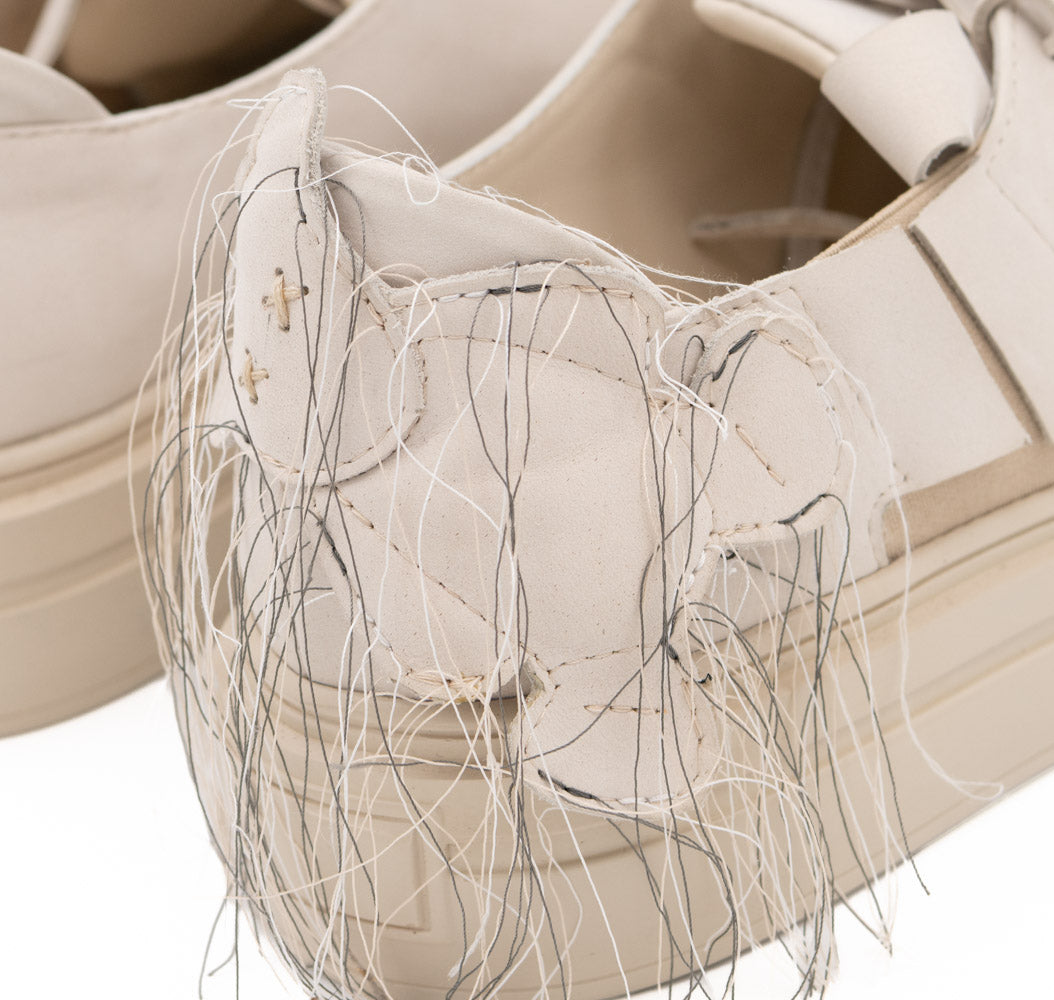 Teddy Soul light beige nubuck low-top sneakers by Mihaela Glavan, close-up of the quilted nubuck bear and its hanging threads.
