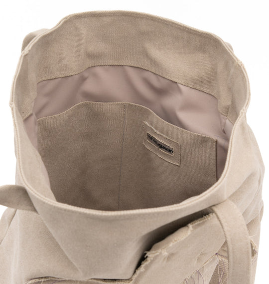 Interior view of the Teddy vegan beige textile totebag showing the pockets and stitched brand label.