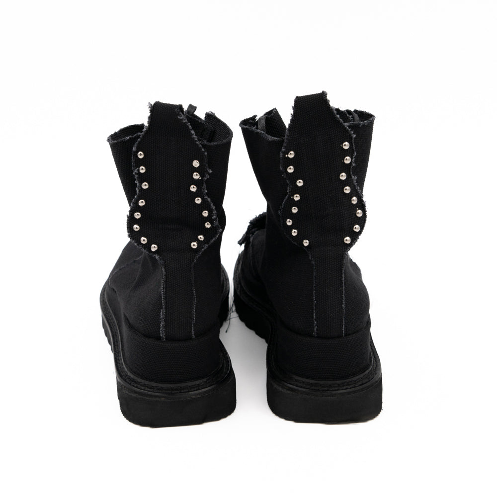 Teddy Vegan black canvas lace-up booties by Mihaela Glavan, back view showing the studded textile panels and black soles.