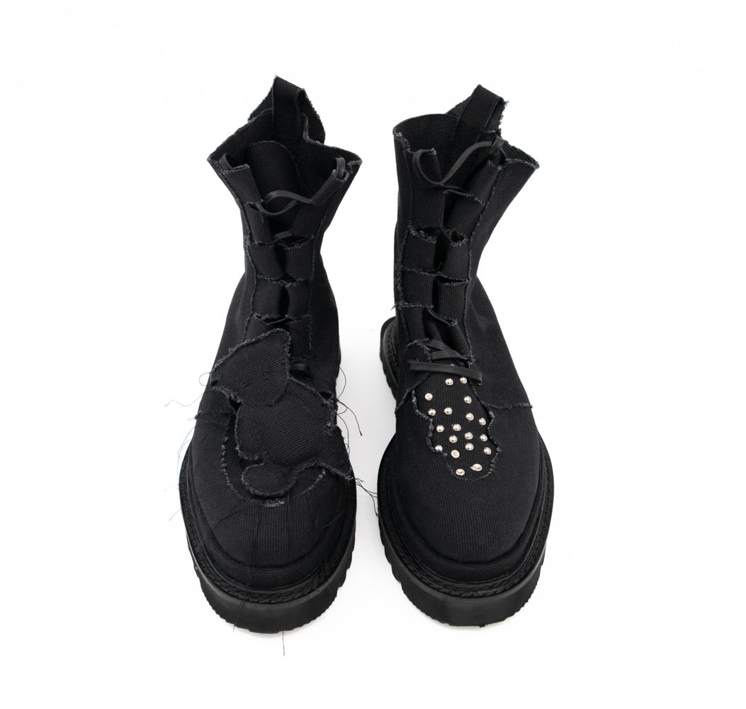 Teddy Vegan black canvas lace-up booties by Mihaela Glavan, front view showing the different teddy bear and stud designs on the two boots.