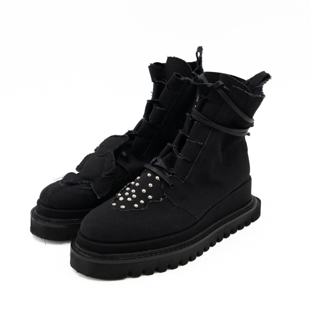 Teddy Vegan black canvas lace-up booties by Mihaela Glavan, three-quarter view showing the asymmetrical bear and stud details.