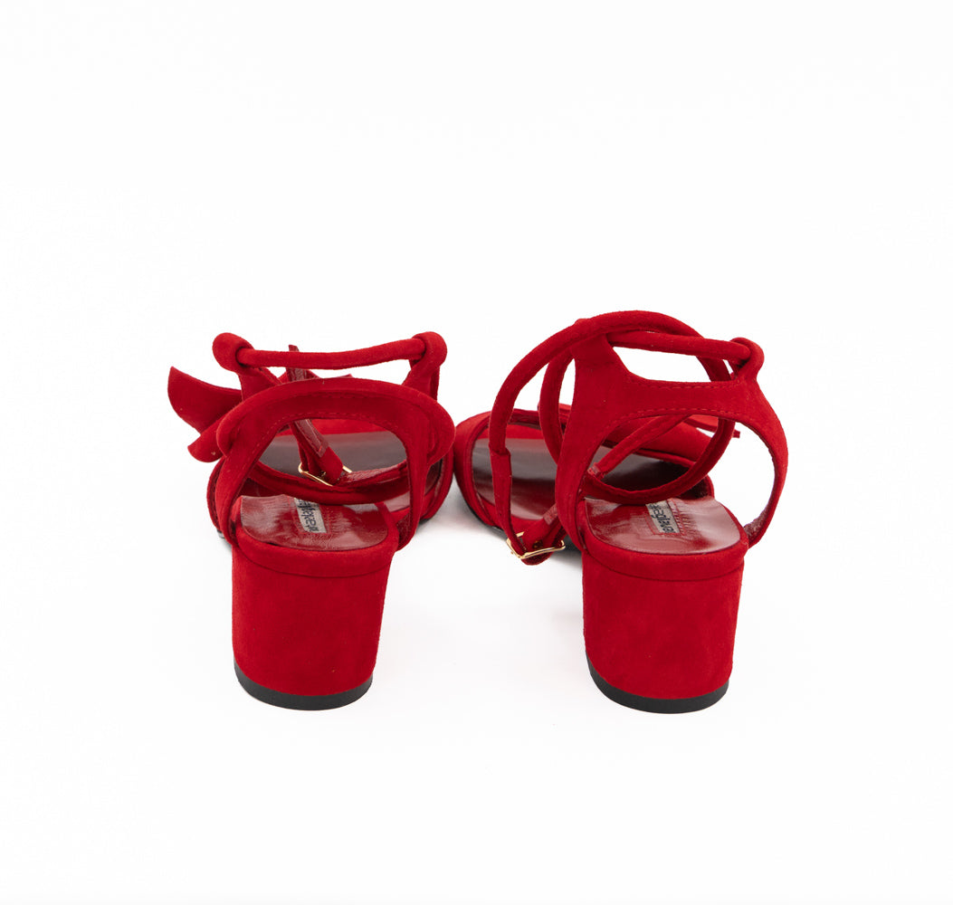 Rear view of Trick Me red suede sandals, showing the suede-covered block heels and ankle straps.