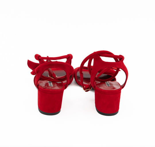 Rear view of Trick Me red suede sandals, showing the suede-covered block heels and ankle straps.