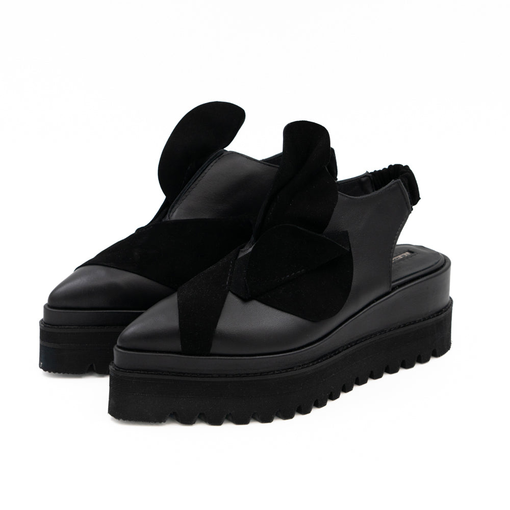 Tulips black leather open-back shoes by Mihaela Glavan, three-quarter front view with sculptural suede flowers.