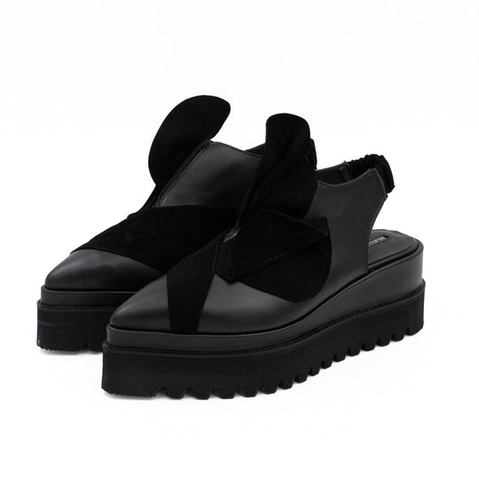 Tulips black leather open-back shoes by Mihaela Glavan, three-quarter front view with sculptural suede flowers.