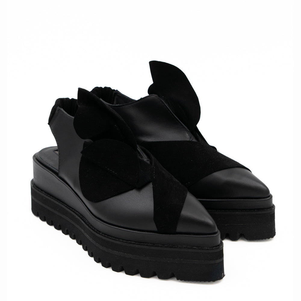 Tulips black leather open-back shoes, opposite three-quarter view showing the floral details and raised black soles.