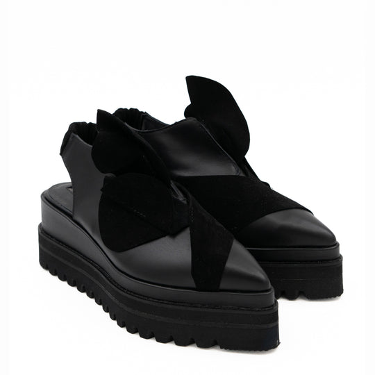 Tulips black leather open-back shoes, opposite three-quarter view showing the floral details and raised black soles.