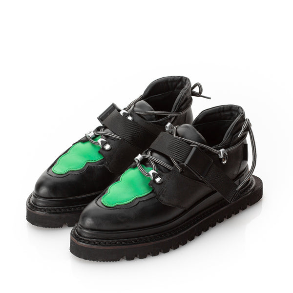 Black leather flat platform shoes with green leather detail