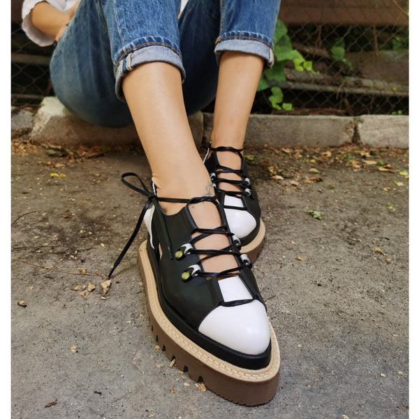 Black and white leather flat platform shoes with cut-out details