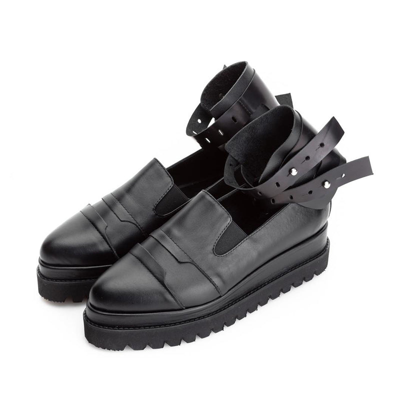 Black leather shoes with ankle double strap, metal accessories and high sole