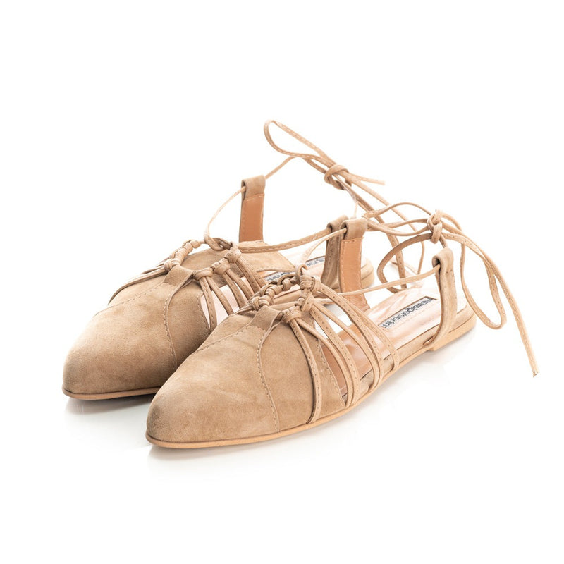 Beige suede flats with natural leather lining, showcasing comfort and style.