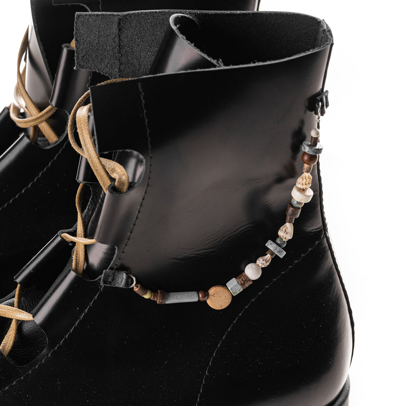 Black booties with natural stones accessories