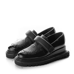 Black leather flat platform shoes with shell-quilted details