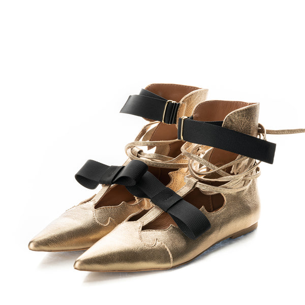 Fashionable golden leather ankle boots with stylish ribbon bow