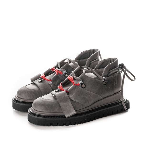 Grey leather flat platform shoes with different texture and black geometrical sole.